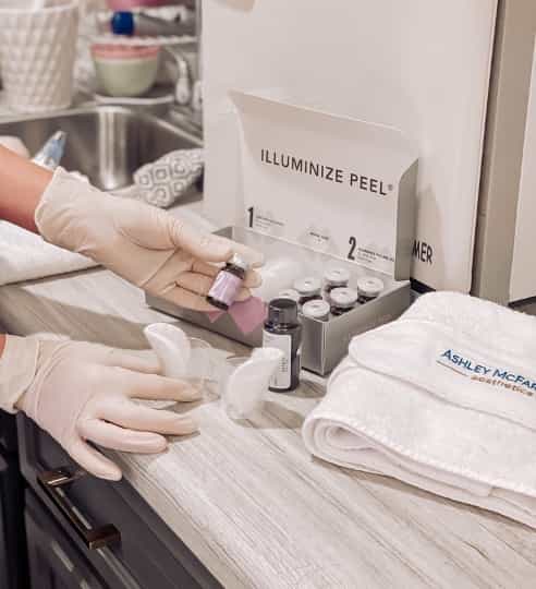 image of hands wearing gloves preparing chemical peel solution